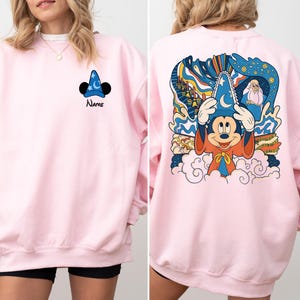 May include: Pink sweatshirt with a Mickey Mouse design on the back and a Mickey Mouse hat design on the front. The text "Name" is printed below the hat design.