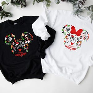 Pu&ograve; includere: Felpe nere e bianche con un design a forma di Mickey Mouse pieno di grafiche a tema natalizio. Il design include fiocchi di neve, omini di pan di zenzero e il testo "Merry Christmas" e "Joy to the World".