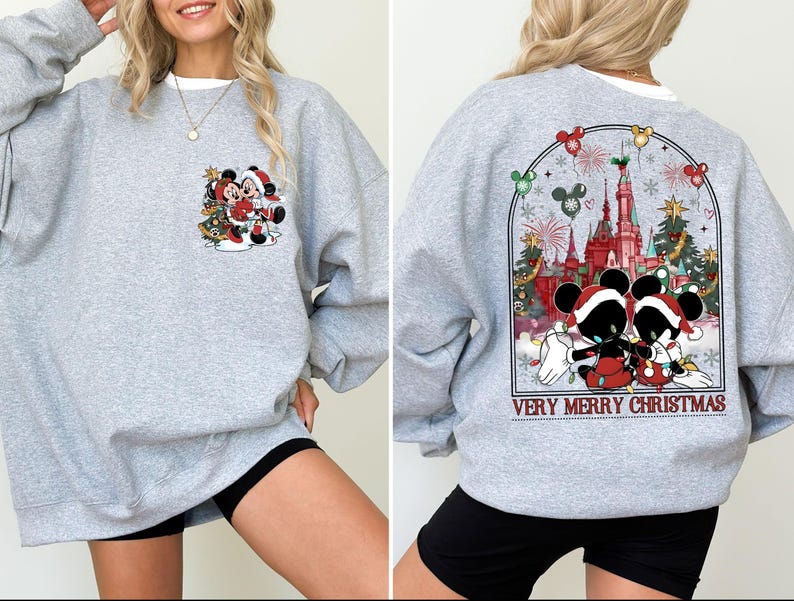 May include: Gray sweatshirt with a Christmas theme featuring Mickey Mouse and Minnie Mouse in front of a castle with the text "Very Merry Christmas".