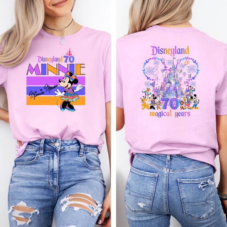 May include: Pink t-shirt with a purple, orange, and white striped design featuring Minnie Mouse and the text "Disneyland 70 Minnie". The back of the shirt features a purple and blue illustration of Sleeping Beauty's castle with fireworks and the text "Disneyland 70 magical years".