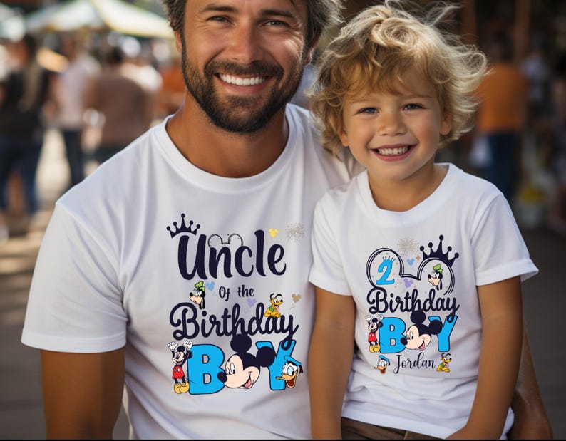 May include: Two white t-shirts with a Mickey Mouse theme. The larger shirt says "Uncle of the Birthday Boy" with Mickey Mouse and friends. The smaller shirt says "2 Birthday Boy Jordan" with Mickey Mouse and friends.