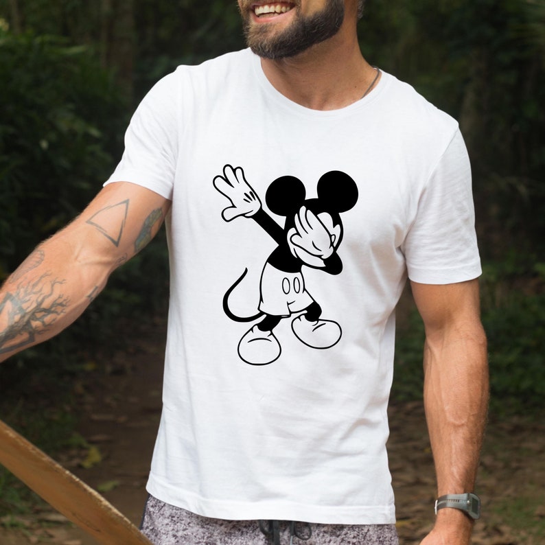 May include: White t-shirt with a black and white illustration of Mickey Mouse doing the dab.