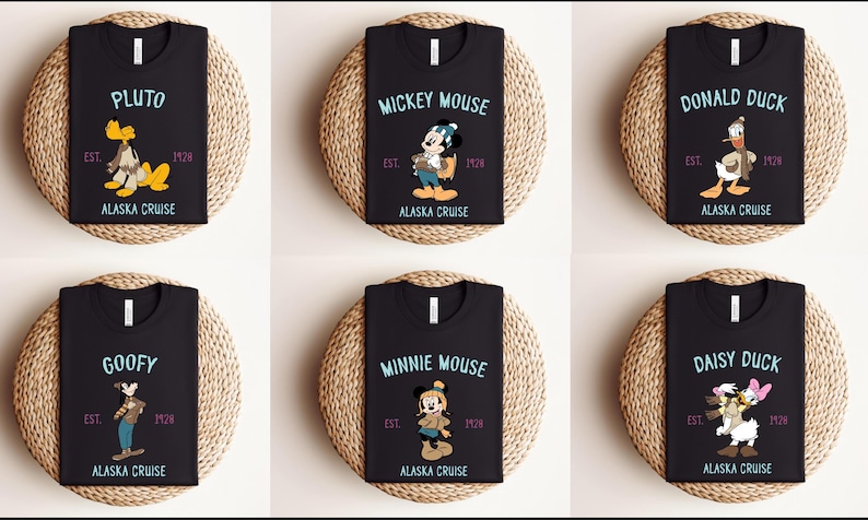May include: Black t-shirts featuring Disney characters Pluto, Mickey Mouse, Donald Duck, Goofy, Minnie Mouse, and Daisy Duck. Each shirt has the character's name, the text "Alaska Cruise", and the year "1928" or "1924". The shirts are displayed on round woven mats.