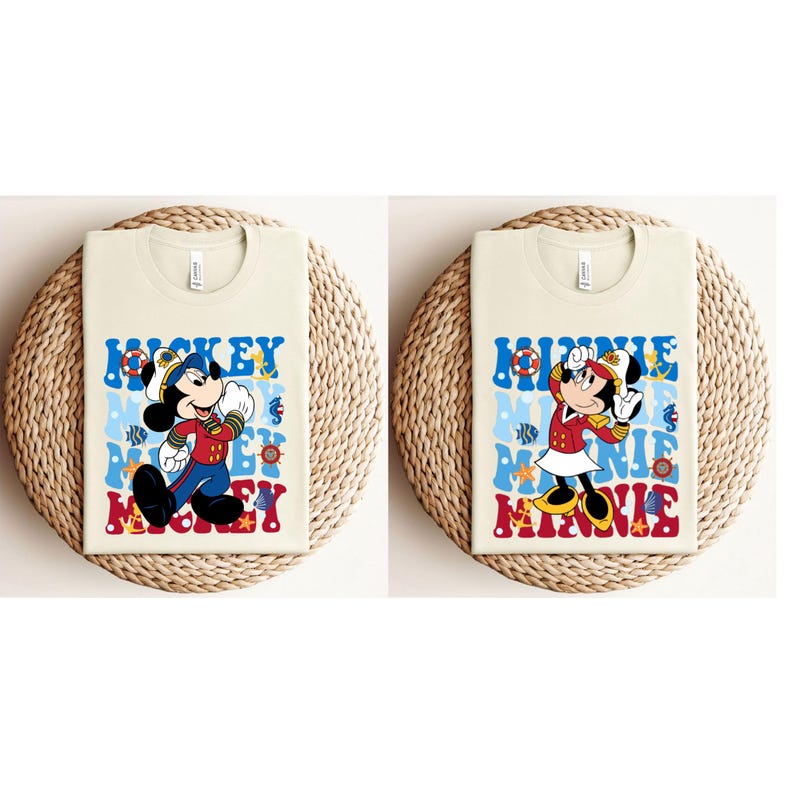 May include: Two beige t-shirts with a nautical theme. The left shirt features Mickey Mouse in a sailor outfit with the word "Mickey" repeated in a retro font. The right shirt features Minnie Mouse in a sailor outfit with the word "Minnie" repeated in a retro font.