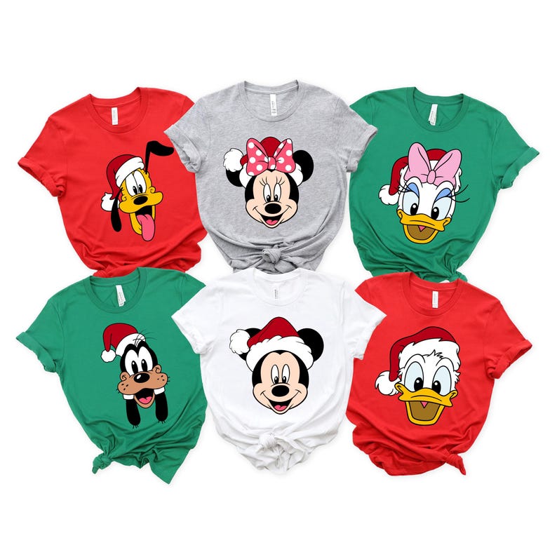 May include: Six Christmas themed t-shirts featuring different Disney characters wearing Santa hats. The characters include Mickey Mouse, Minnie Mouse, Donald Duck, Goofy, and Pluto.