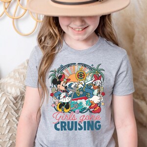 May include: A gray t-shirt with a colorful graphic of Mickey Mouse and Minnie Mouse dressed as sailors on a ship. The text "Girls gone cruising" is printed below the graphic.