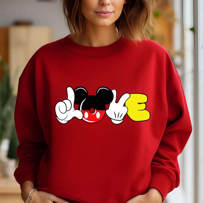 May include: Red sweatshirt with a graphic of Mickey Mouse's head and hands spelling out "LOVE".
