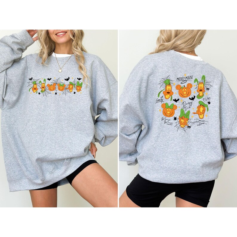 May include: A heather gray sweatshirt with a white collar. The front features a Halloween-themed design with cartoon characters and the word "Boo". The back displays more cartoon characters in pumpkin form, with the words "Mickey Mouse" above them.