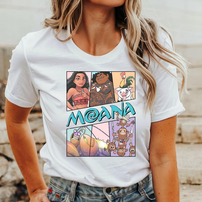 May include: White t-shirt with a colorful graphic print of characters from the animated movie Moana. The graphic includes Moana, Maui, Pua the pig, Hei Hei the rooster, and the Kakamora.