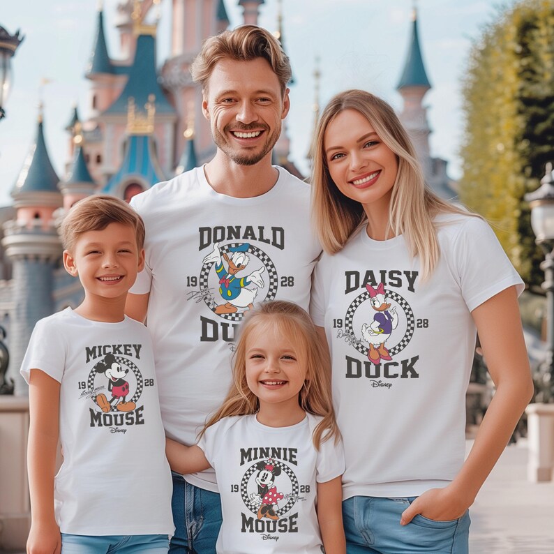 May include: A family of four wearing white t-shirts with Disney character graphics. The shirts feature Mickey Mouse, Minnie Mouse, Donald Duck, and Daisy Duck. The text on the shirts reads "Mickey Mouse", "Minnie Mouse", "Donald Duck", and "Daisy Duck".