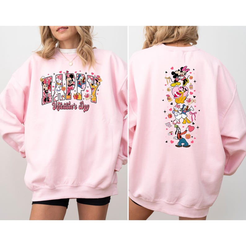 May include: A light pink sweatshirt featuring the words "Happy Valentine's Day" with Disney characters. The back of the sweatshirt has a vertical design with more Disney characters and hearts.