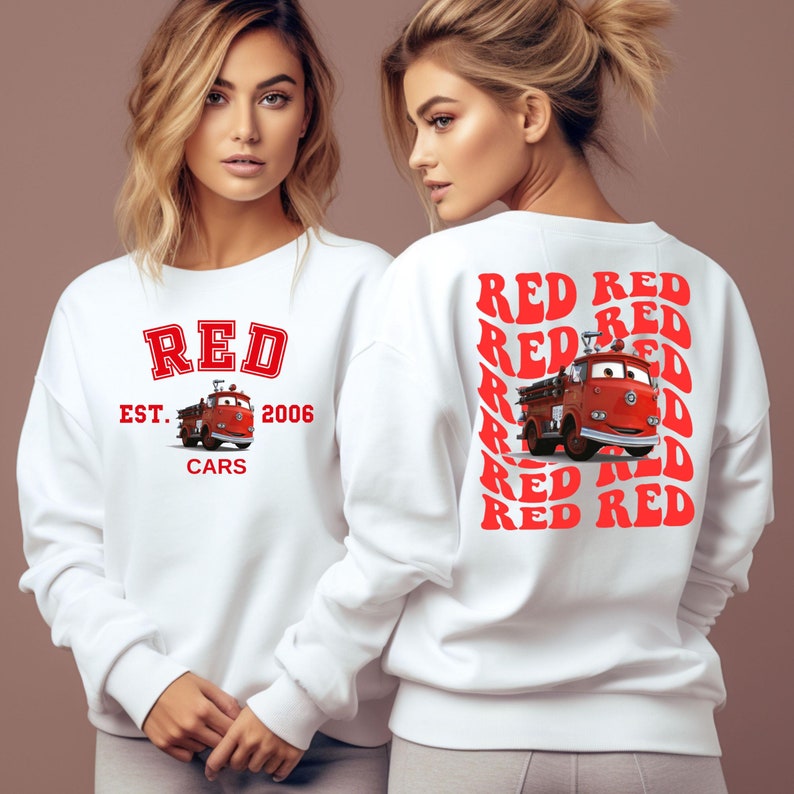 May include: White sweatshirt with a red graphic on the front that says "RED EST. 2006 CARS" and a red fire truck from the movie Cars. The back of the sweatshirt has a repeating pattern of the word "RED" in red.