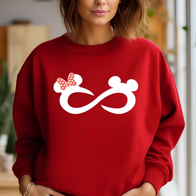 May include: Red sweatshirt with a white infinity symbol design featuring a cartoon mouse with a red bow.