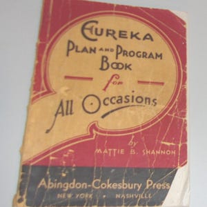 May include: Vintage book cover with the title "Eureka Plan and Program Book for All Occasions" in black and red lettering. The cover is aged, with visible wear and tear, and the author is Mattie B. Shannon.
