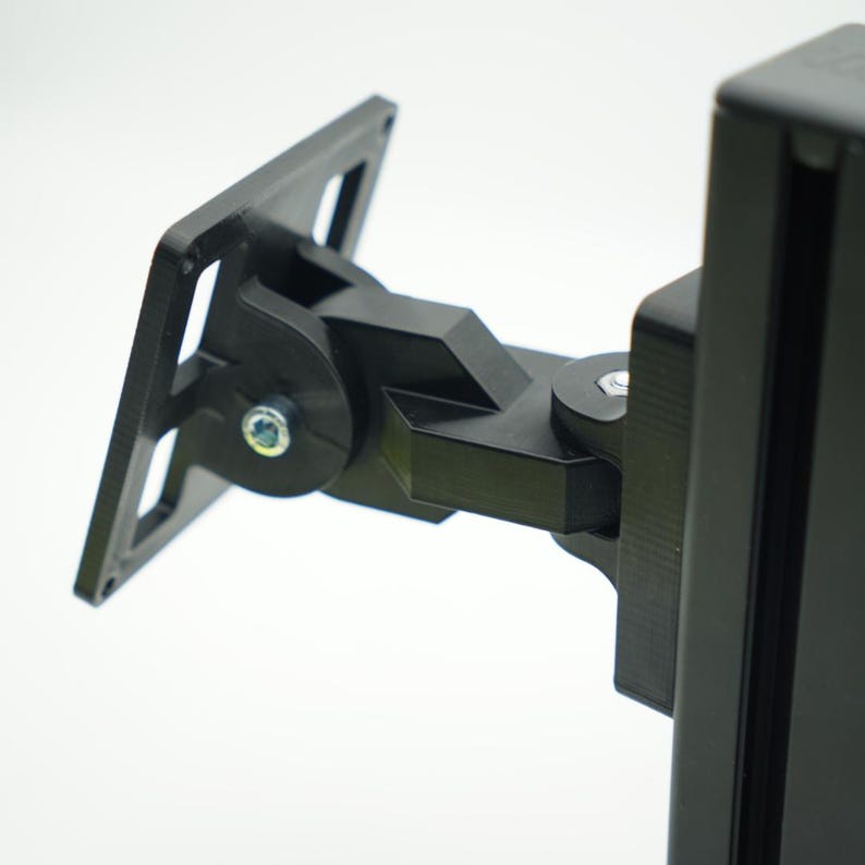 May include: A black metal TV wall mount with a swivel arm and a rectangular base plate. The mount is designed to attach to a wall and hold a TV.