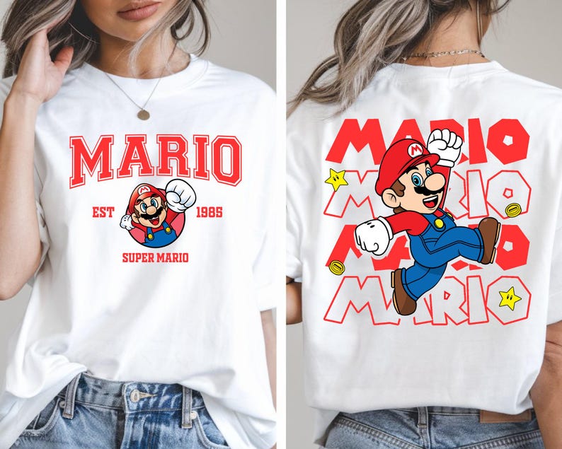 May include: White t-shirt featuring a front and back design of the video game character Mario. The front design includes the word "MARIO" in red block letters, the character's image, and the text "EST 1985 SUPER MARIO". The back design repeats the word "MARIO" and the character.