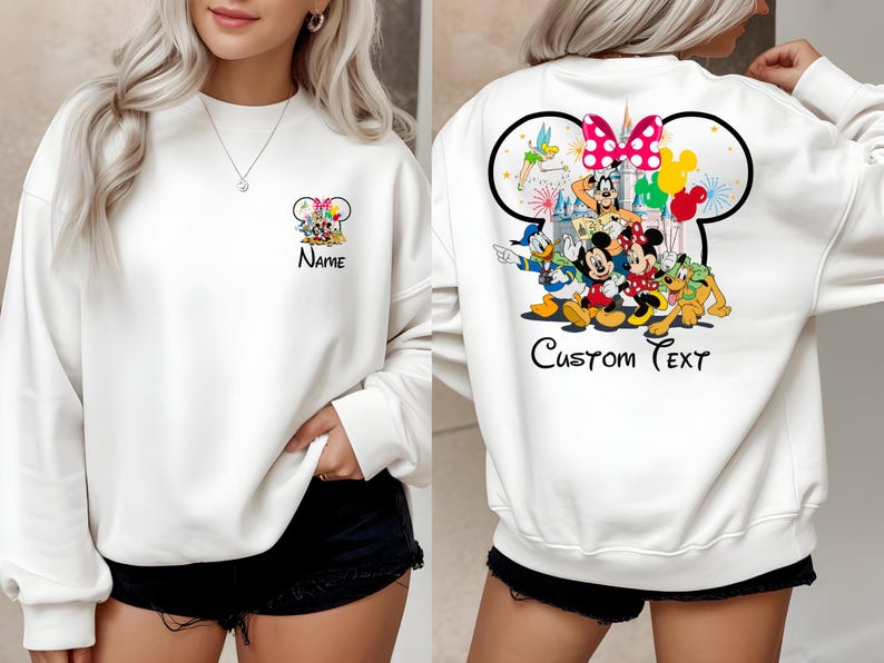 May include: White sweatshirt featuring a colorful Disney character design. The front displays a Mickey Mouse head with characters and the word "Name". The back has a larger design with Mickey and Minnie Mouse, Donald Duck, and Pluto, with the words "Custom Text".
