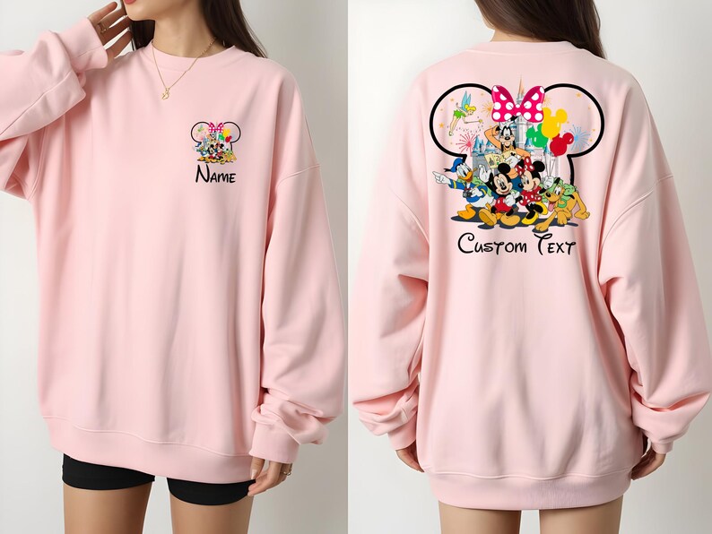 May include: Light pink sweatshirt featuring a Disney character design on the front and back. The front displays a group of characters with the word "Name" below. The back features a larger design with "Custom Text".