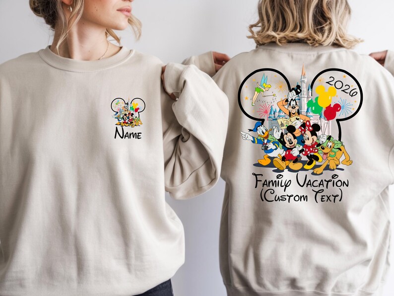 May include: Beige sweatshirt featuring a Mickey Mouse ear design with Disney characters. The front has a small design with the name, and the back has a larger design with the text "Family Vacation (Custom Text)" and the year 2026.