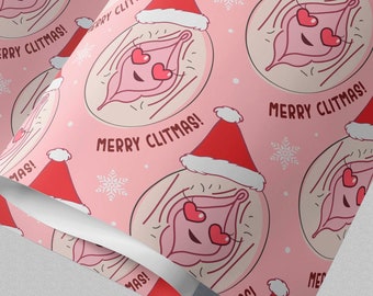 May include: A roll of pink wrapping paper featuring a repeating pattern of cartoon illustrations of a clitoris wearing a red and white Santa hat with heart-shaped eyes. The text MERRY CLITMAS! is printed in black next to each illustration.