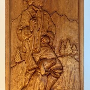 Relief Carving of Bavarian Hunter with Rifle on shoulder Walking with Dog