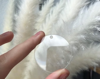 May include: A clear round acrylic ornament with a hole at the top for hanging.