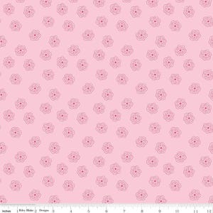 May include: Pink fabric with a repeating pattern of small, stylized flowers. Each flower has a dark pink center and a light pink outline. The background is a solid, light pink color. The fabric is measured in inches.