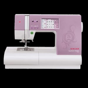 May include: A lavender and white Singer Quantum Stylist sewing machine featuring a digital display screen with various stitch patterns, a needle, a presser foot, and the Singer logo printed on the front panel.