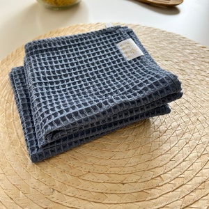 In photo are blueberry color dish cloth on the table.