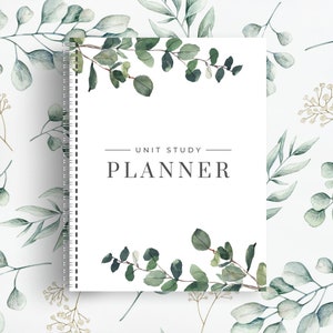 May include: A white planner with a green eucalyptus leaf design and the text "UNIT STUDY PLANNER" on the front cover.