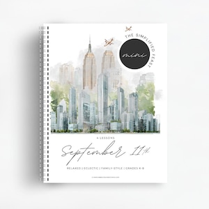 May include: A spiral-bound notebook with a white cover featuring a watercolor illustration of a city skyline. Text on the cover reads: The Simplified Feast mini, 4 Lessons, September 11th, Relaxed | Eclectic | Family-Style | Grades K-8.