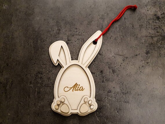Personalized wooden pendant in rabbit shape. Made from three layers of high-quality, 3 mm birch plywood, individual name engraving