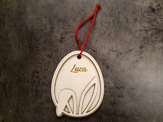 Personalized Easter egg pendant: 2-layer birch plywood, 3 mm thick, 120 x 94 mm, with bunny ears. Individual laser engraving for desired name