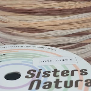 May include: A spool of multi-colored raffia ribbon in shades of brown, beige, and white. The ribbon is labeled "CODE - MULTI-5" and "Sisters Natura".