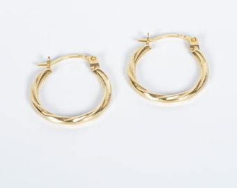 May include: A pair of gold hoop earrings with a twisted design. The earrings are small and delicate.