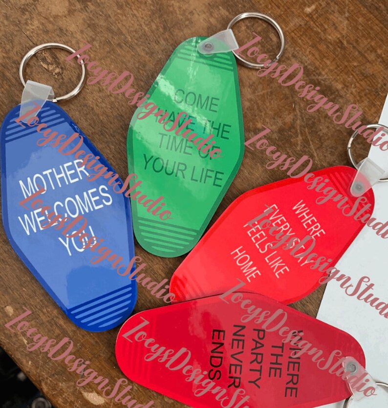 May include: Four motel-style keychains in blue, green, and red. Each keychain has a different phrase in white text: "Mother Welcomes You!", "Come Have The Time Of Your Life", "Where Every Stay Feels Like Home", and "Where The Party Never Ends".