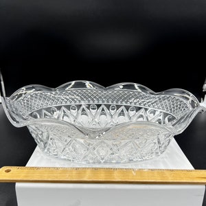May include: A clear glass bowl with a scalloped edge and a diamond pattern. The bowl is approximately 10 inches in diameter.