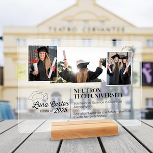 May include: Clear acrylic graduation photo display with three images of a graduate in a cap and gown. The display includes the graduate's name, university, degree, and a quote. It rests on a wooden base.