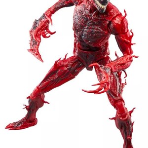 May include: A red action figure of the Marvel Comics character Carnage. The figure is in a dynamic pose, with a detailed sculpt featuring a textured, symbiote-like appearance. The figure has a white and black face and sharp, claw-like appendages.