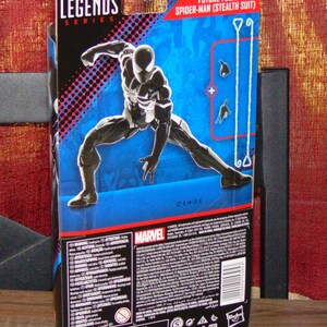 May include: Marvel Legends Series action figure packaging featuring Future Foundation Spider-Man (Stealth Suit). The box is primarily blue with a dynamic image of the figure in a black and white stealth suit. The Marvel logo is prominently displayed.