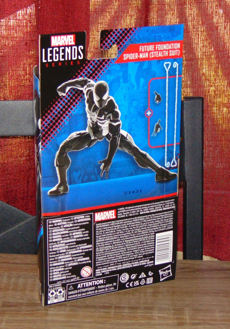 May include: Marvel Legends Series action figure packaging featuring Future Foundation Spider-Man (Stealth Suit). The box is primarily blue with a dynamic image of the figure in a black and white stealth suit. The Marvel logo is prominently displayed.