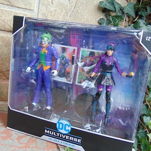 May include: A DC Multiverse action figure set featuring The Joker and Punchline. The Joker figure is in a purple suit with green hair and an orange vest. Punchline is in a purple and black outfit. The packaging includes character art and the DC Multiverse logo.
