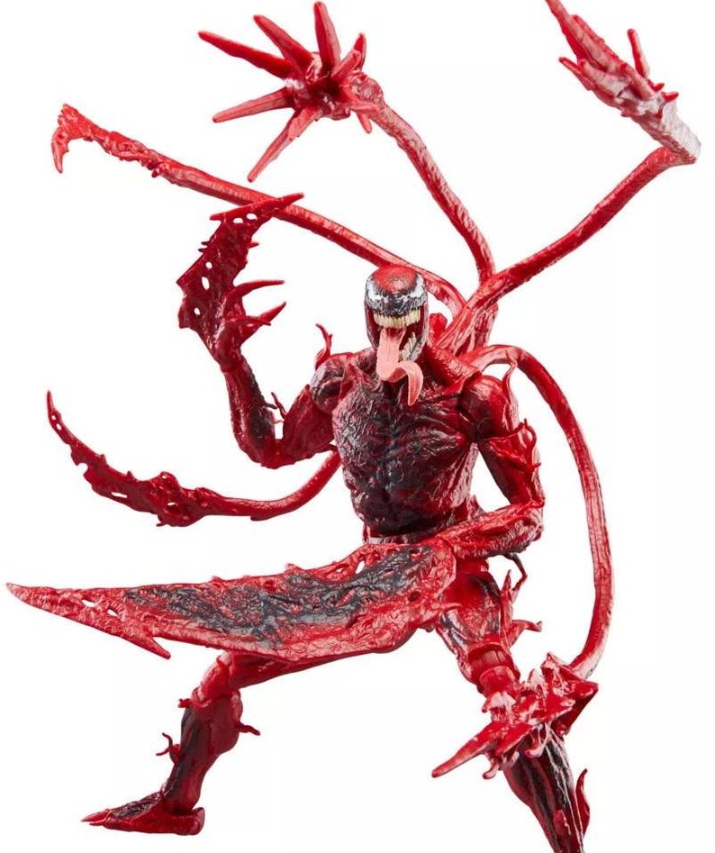 May include: A red and black action figure of the Marvel Comics character Carnage. The figure has multiple tendrils and blade-like appendages. The figure is in a dynamic pose with its tongue extended.