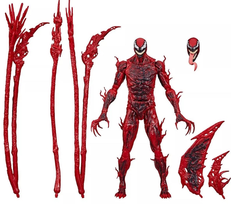 May include: A red action figure of the character Carnage, with multiple interchangeable accessories. The figure has a detailed, textured design and is posed with its arms outstretched. Accessories include multiple red tendrils and wing-like attachments.