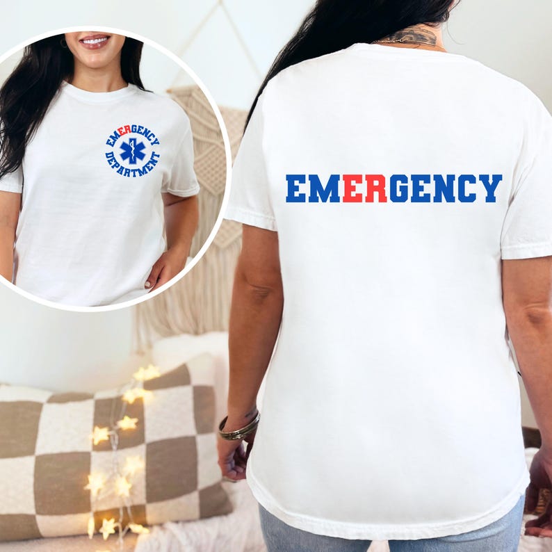 May include: White t-shirt with a blue and red "EMERGENCY" graphic on the back and a blue star of life graphic inside a circle with the text "EMERGENCY DEPARTMENT" on the front.