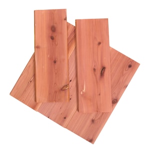 May include: Four pieces of cedar wood planks, arranged in a diamond shape, with a natural reddish-brown color and visible knots.