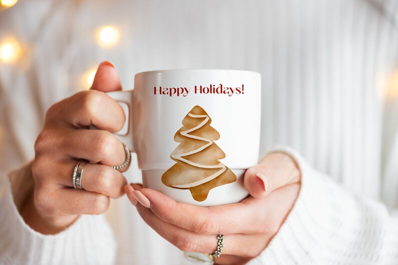 May include: White ceramic mug with a brown gingerbread tree design and the text "Happy Holidays!" in red.