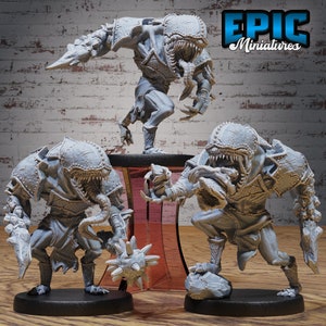 May include: Three gray, detailed, miniature figures of creatures with sharp teeth and claws. The figures are posed in a dynamic, action-ready stance. The figures are from the Epic Miniatures brand.