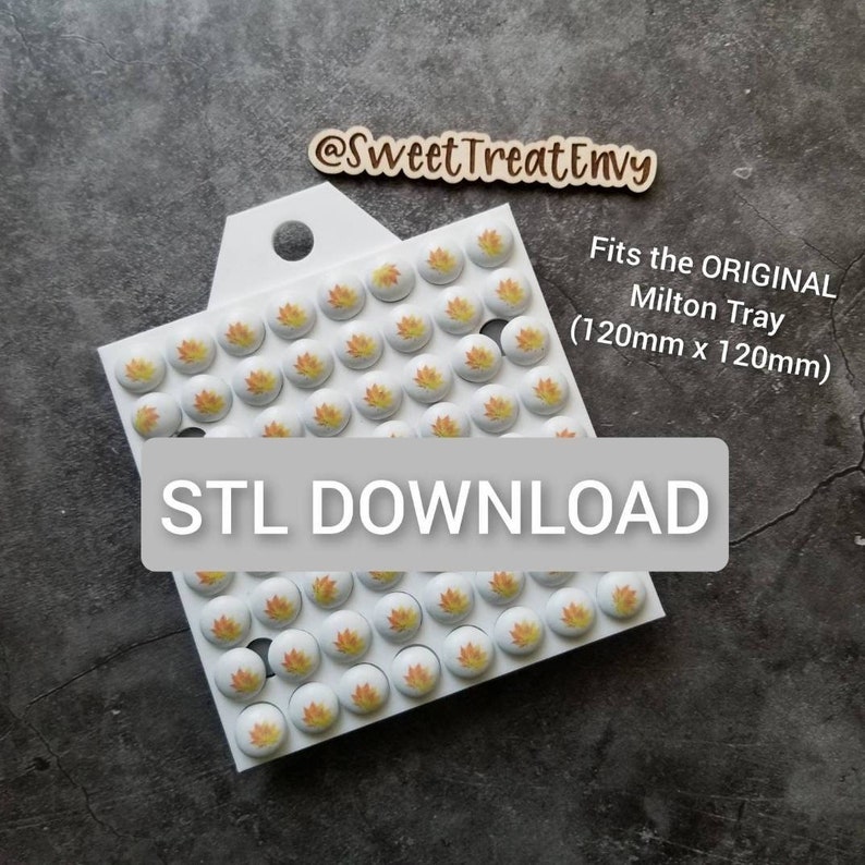 May include: White tray with a cutout handle, filled with 64 small round white tiles with orange and yellow leaf designs. The tray is labeled "Fits the ORIGINAL Milton Tray (120mm x 120mm)" and "STL DOWNLOAD".