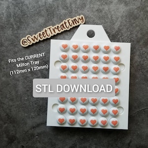 May include: A white tray with 48 pink heart-shaped candy molds. The tray is labeled "Fits the CURRENT Milton Tray (112mm x 120mm)" and "STL DOWNLOAD".